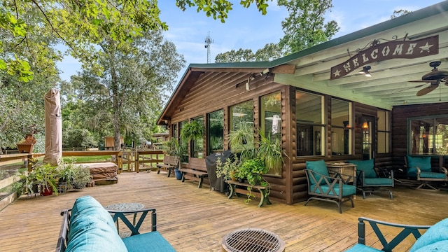 wooden deck with a sunroom and ceiling fan