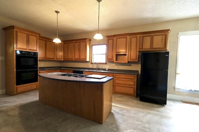 kitchen featuring a kitchen island, pendant lighting, sink, black appliances, and a textured ceiling