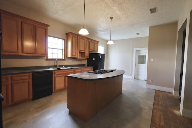 kitchen with sink, decorative light fixtures, a textured ceiling, a kitchen island, and black appliances