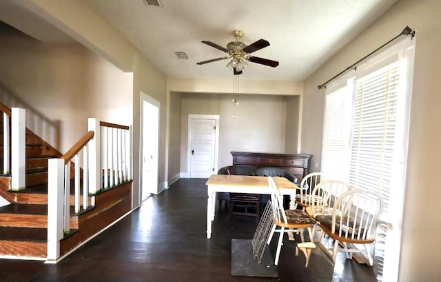 dining room with ceiling fan and dark hardwood / wood-style floors