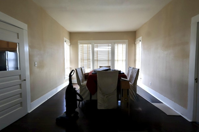 dining area with dark hardwood / wood-style flooring