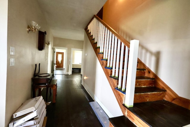 staircase featuring wood-type flooring