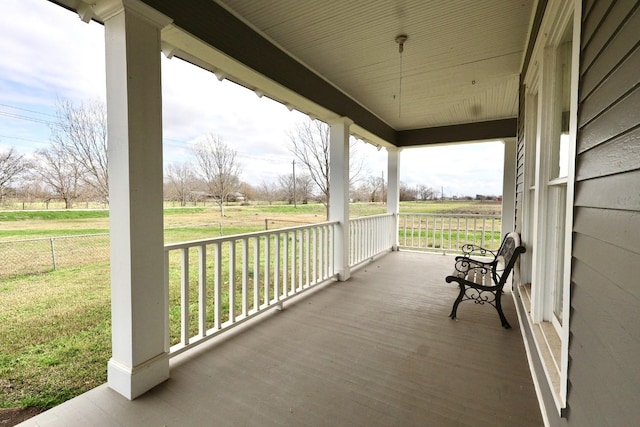 view of patio / terrace featuring a rural view and a porch