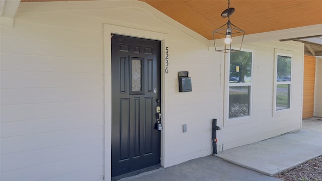 view of exterior entry with covered porch