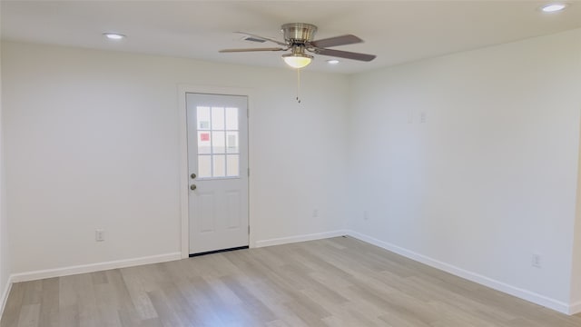 spare room with ceiling fan and light wood-type flooring