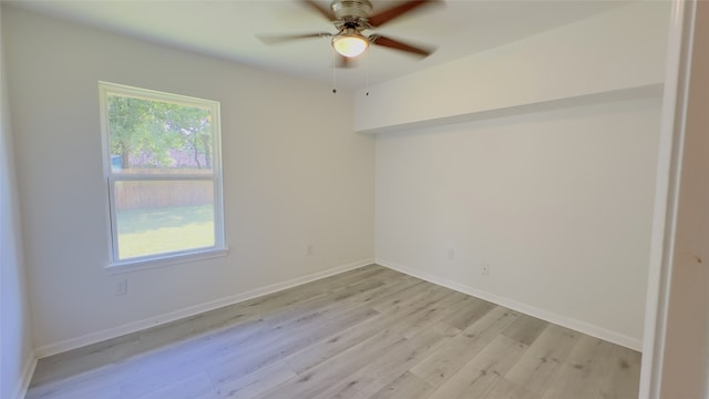 spare room with light hardwood / wood-style flooring and ceiling fan