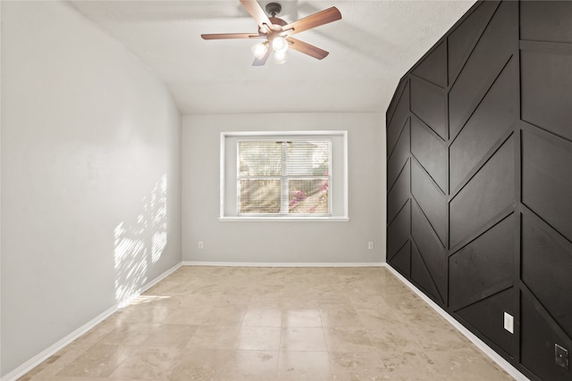 empty room with ceiling fan and lofted ceiling