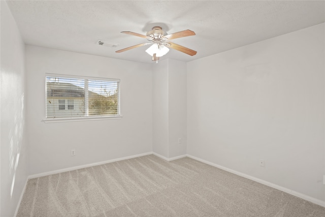 spare room featuring light carpet and ceiling fan