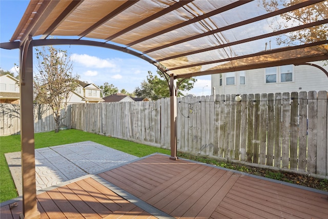 wooden deck with a pergola and a lawn