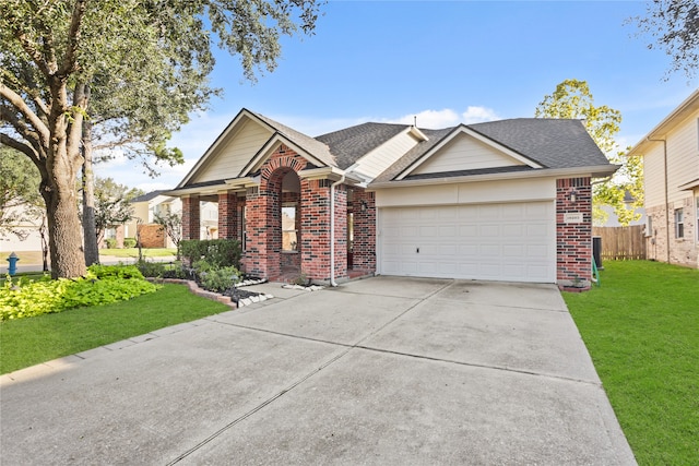 view of front of house with a garage and a front yard