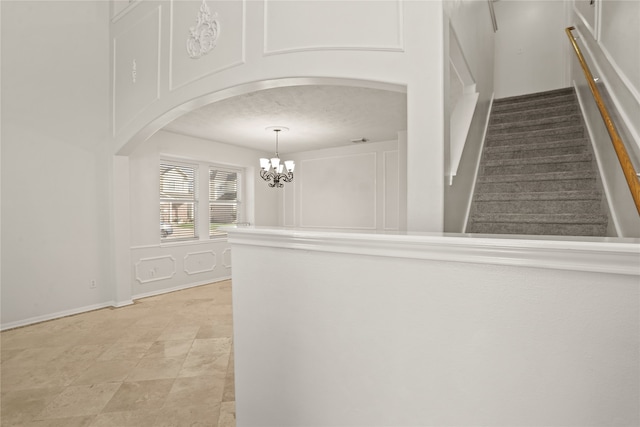 interior space with a textured ceiling and an inviting chandelier