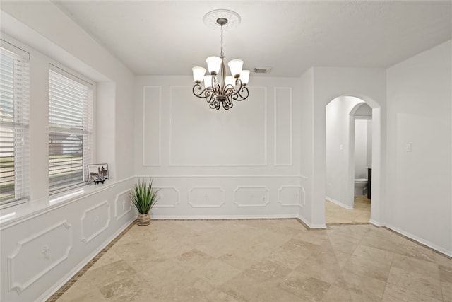 spare room with an inviting chandelier