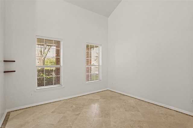 spare room with high vaulted ceiling