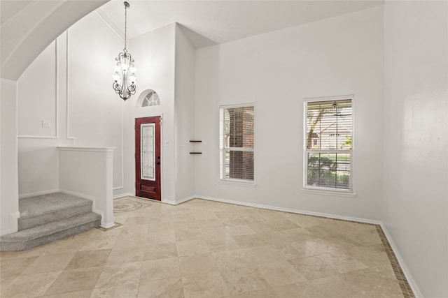 foyer entrance featuring a high ceiling and an inviting chandelier