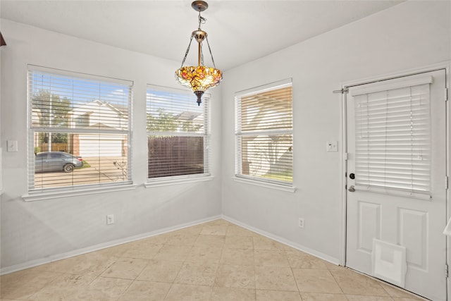 unfurnished dining area with light tile patterned flooring