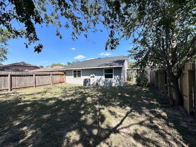 rear view of house with a yard