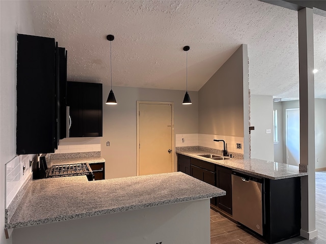 kitchen featuring sink, light hardwood / wood-style flooring, backsplash, kitchen peninsula, and appliances with stainless steel finishes