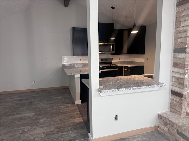 kitchen featuring light stone countertops, appliances with stainless steel finishes, a textured ceiling, decorative light fixtures, and dark hardwood / wood-style floors