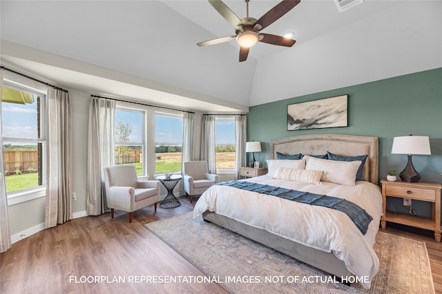 bedroom featuring ceiling fan, wood-type flooring, and lofted ceiling