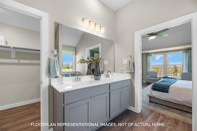 bathroom featuring vanity, hardwood / wood-style flooring, ceiling fan, and lofted ceiling