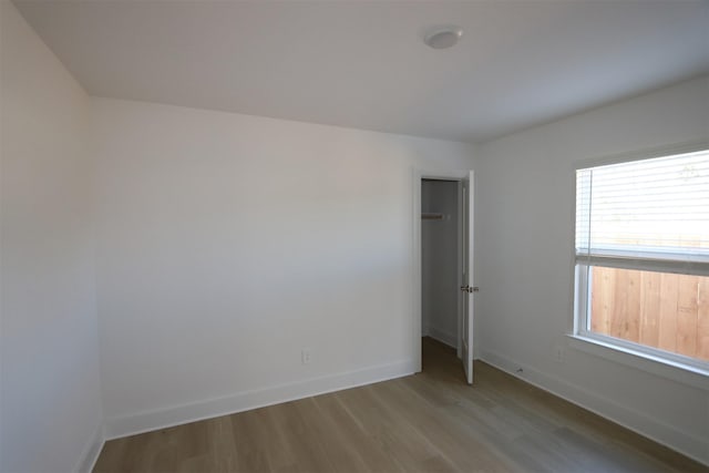 unfurnished room featuring baseboards and wood finished floors