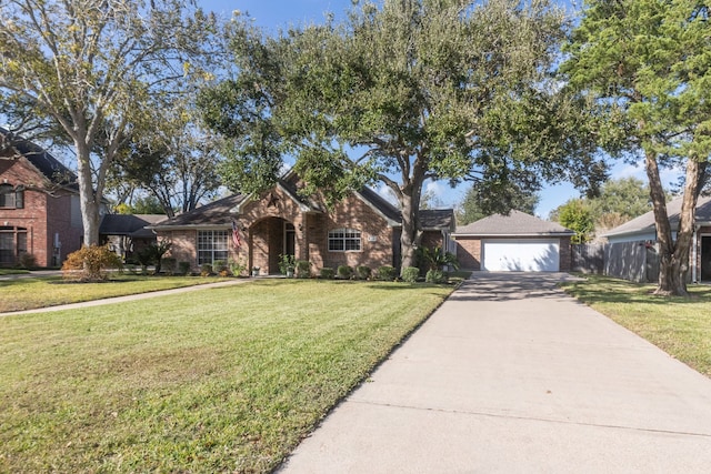 view of front of property with a garage and a front lawn