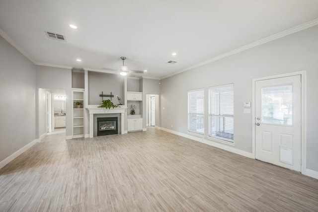 unfurnished living room with light hardwood / wood-style flooring, crown molding, and a tiled fireplace