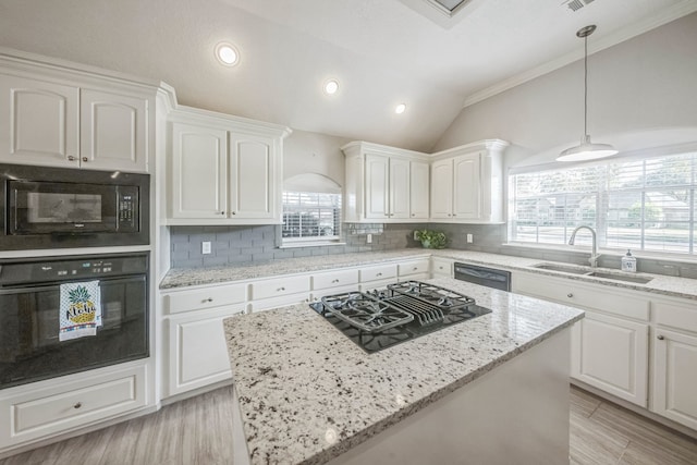 kitchen featuring black appliances, white cabinets, sink, and vaulted ceiling