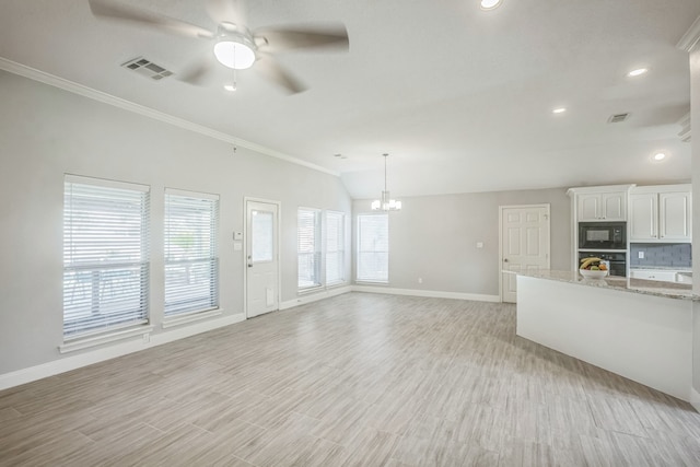 unfurnished living room featuring lofted ceiling, ceiling fan with notable chandelier, light hardwood / wood-style floors, and ornamental molding