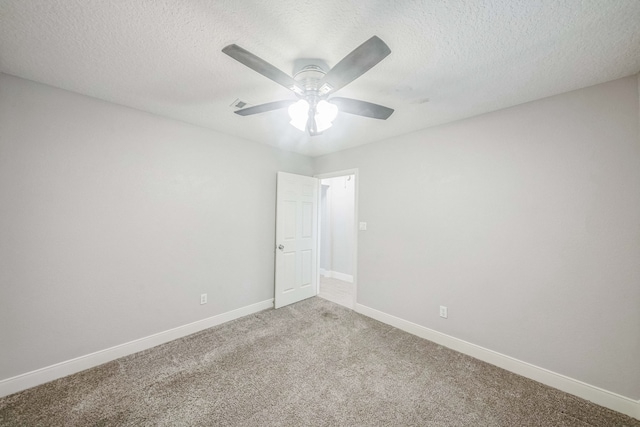 empty room featuring carpet flooring, ceiling fan, and a textured ceiling