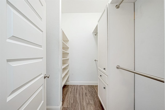 spacious closet with light hardwood / wood-style floors