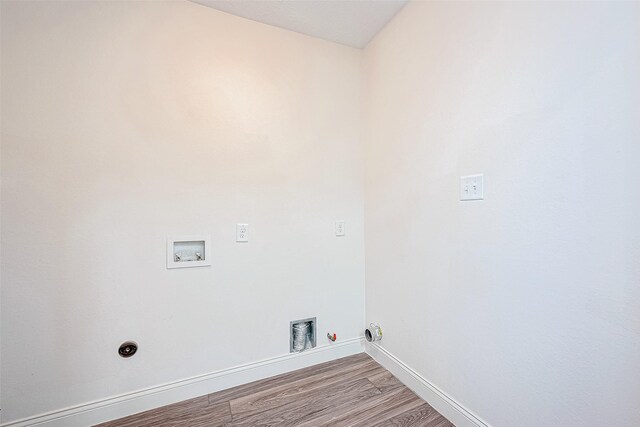 washroom featuring electric dryer hookup, hookup for a gas dryer, light wood-type flooring, and hookup for a washing machine