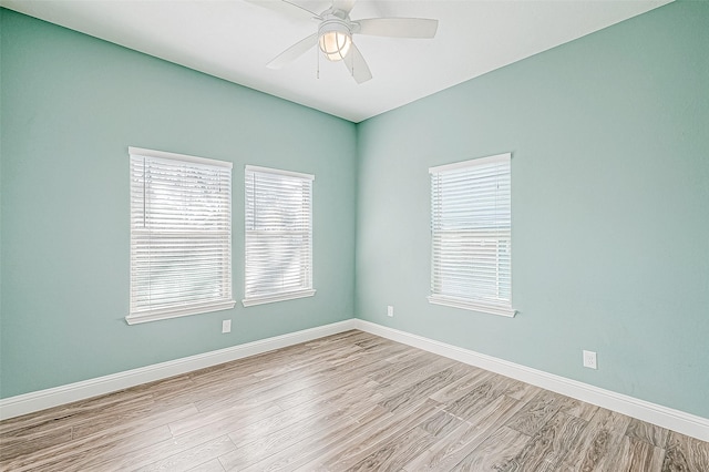 empty room with ceiling fan and light hardwood / wood-style flooring