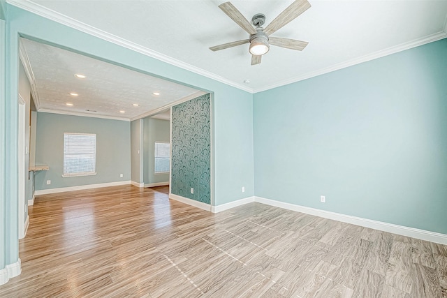 spare room featuring ceiling fan and ornamental molding