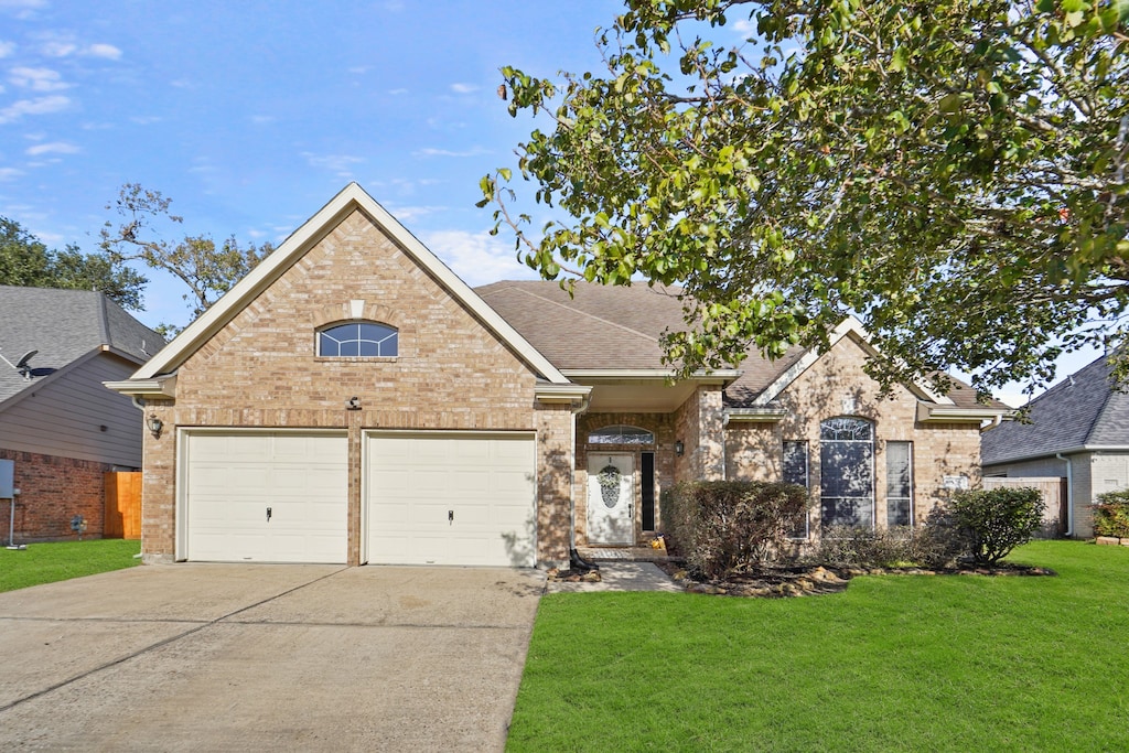 view of front of house with a garage and a front yard