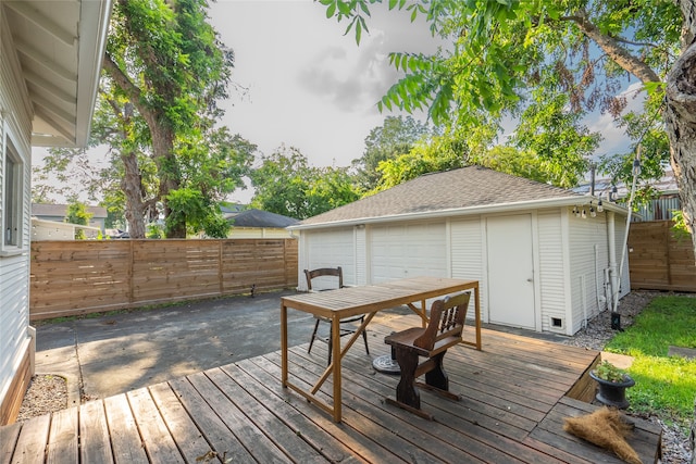 wooden terrace with a garage and an outdoor structure