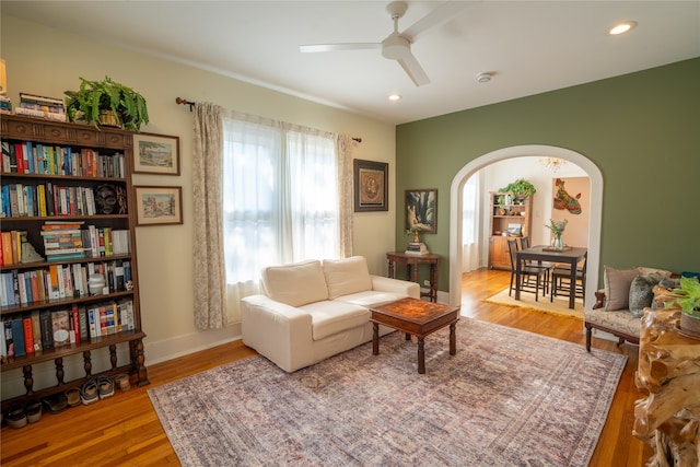 living room featuring ceiling fan and light wood-type flooring