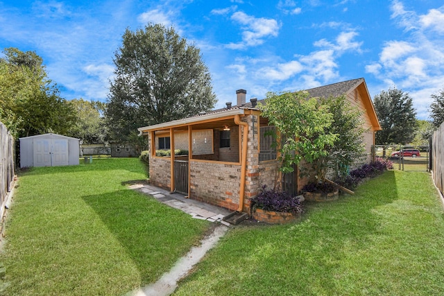 rear view of house with a storage unit and a lawn