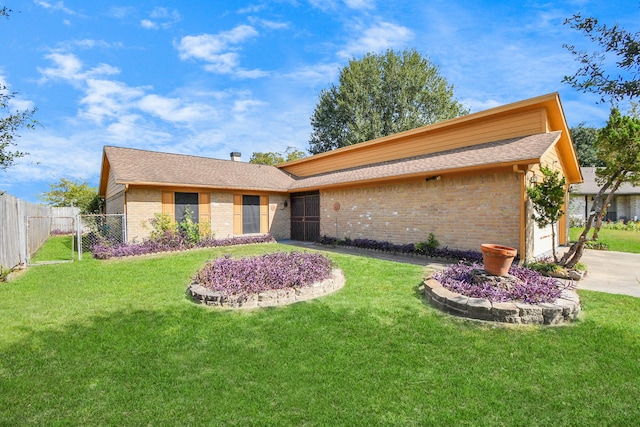 ranch-style home with a front lawn