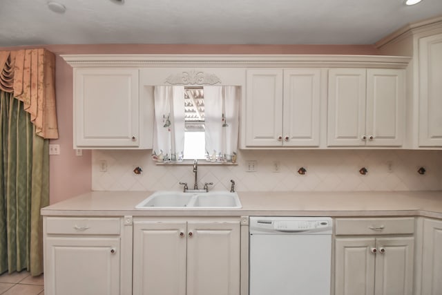 kitchen with white dishwasher, decorative backsplash, white cabinetry, and sink