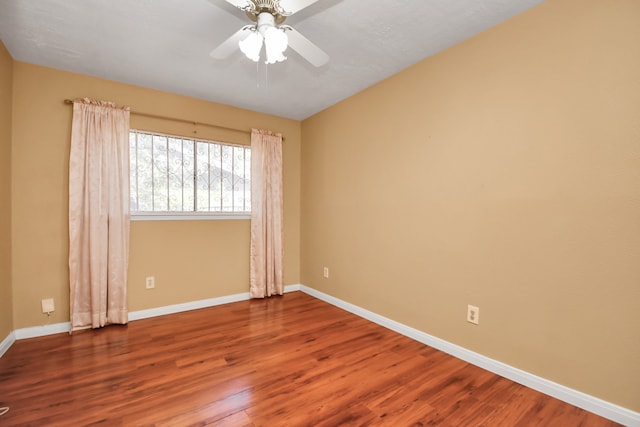 unfurnished room featuring ceiling fan and hardwood / wood-style flooring