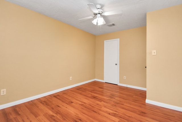 empty room featuring hardwood / wood-style floors, a textured ceiling, and ceiling fan