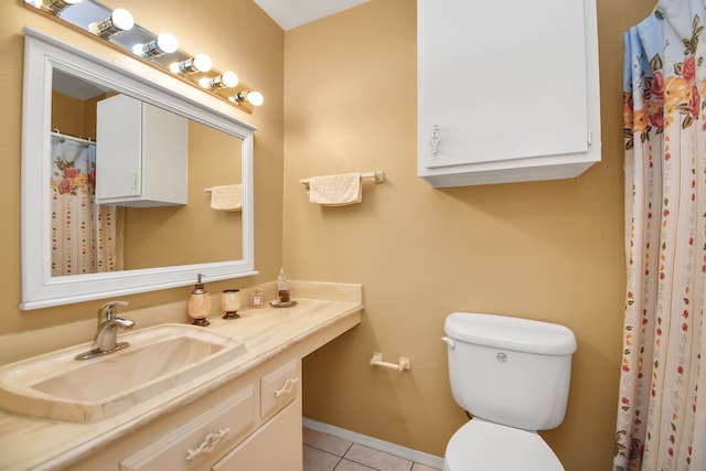 bathroom featuring tile patterned floors, vanity, and toilet