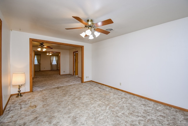 carpeted spare room with ceiling fan