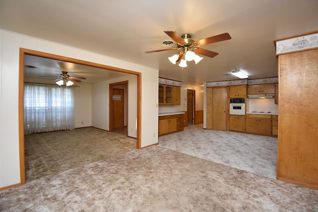 unfurnished living room featuring ceiling fan and light colored carpet