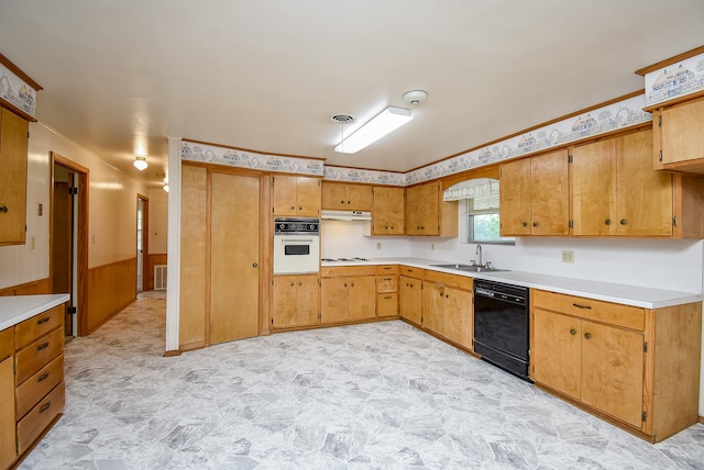 kitchen featuring wood walls, sink, and white appliances