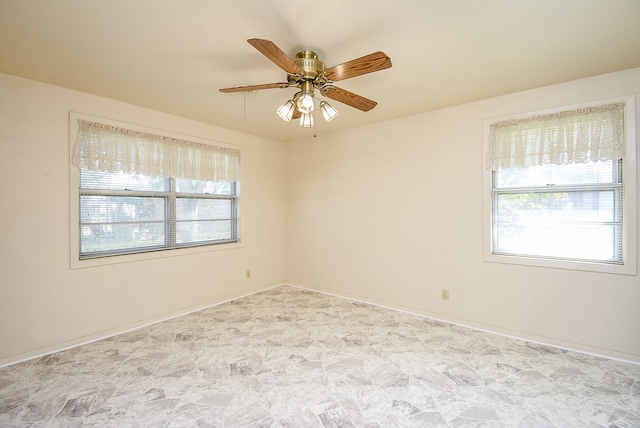 spare room with ceiling fan