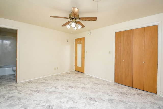 unfurnished bedroom with ceiling fan, connected bathroom, and a closet