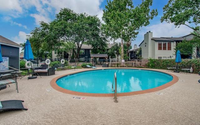 view of swimming pool featuring a patio area