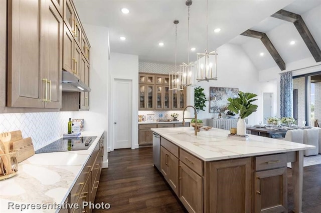 kitchen with beamed ceiling, pendant lighting, decorative backsplash, and a spacious island